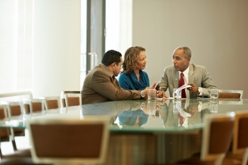 3 people at conference table